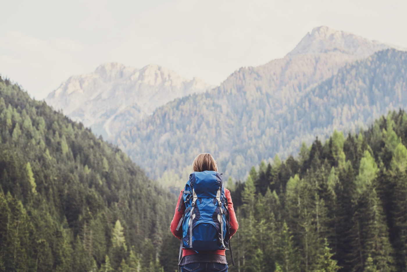 A woman backpacking in the mountains